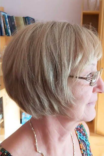 Beige blonde bob with soft bangs and layers
