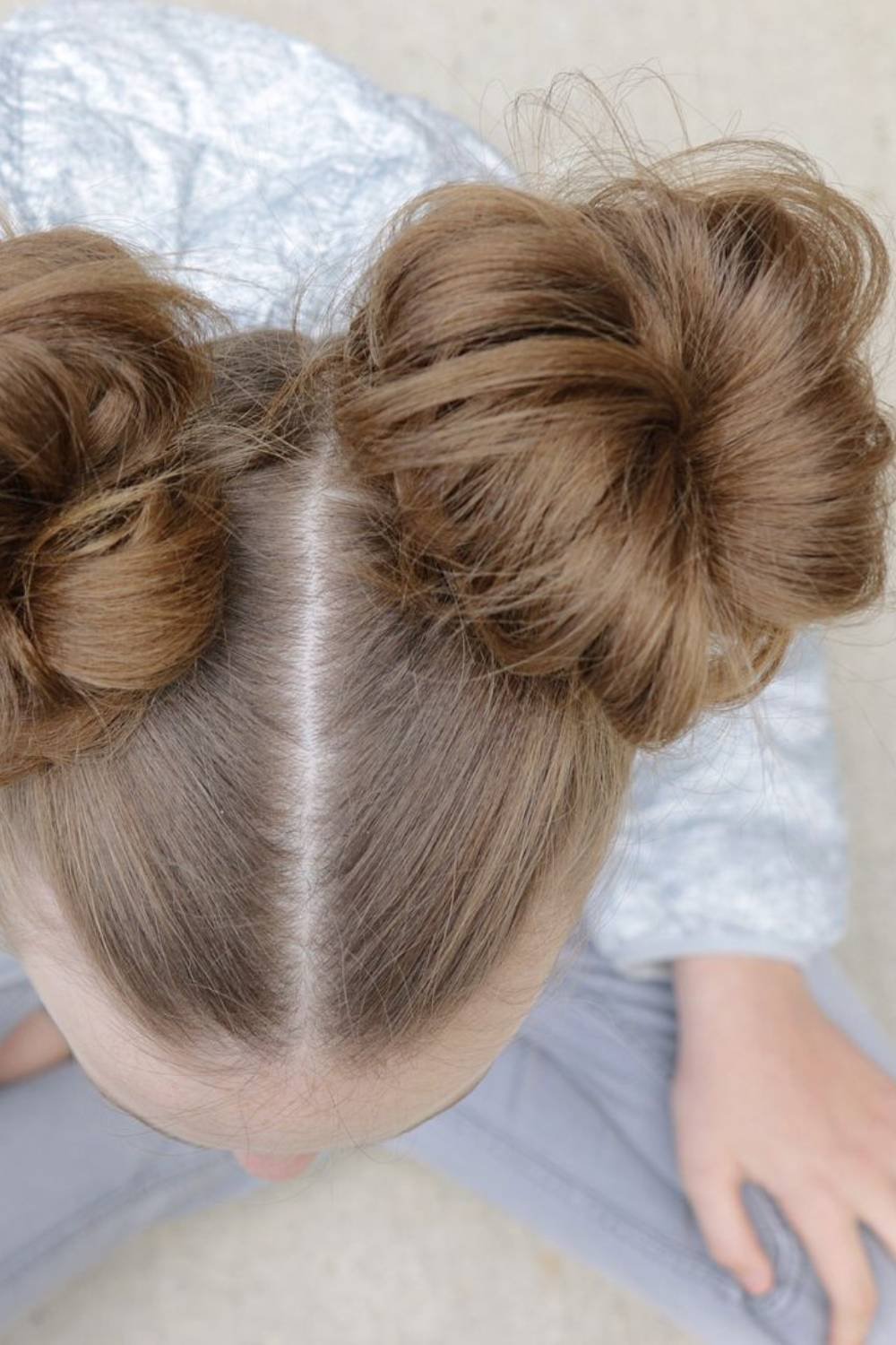 Playful double bun hairstyle positioned high on each side