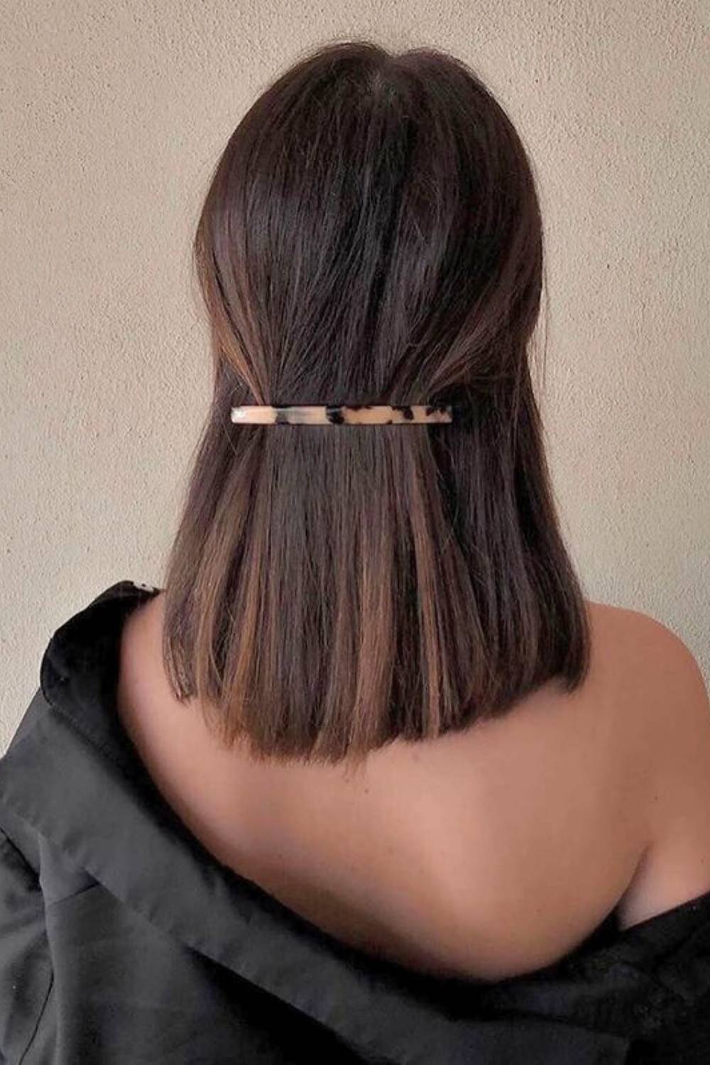 Half-up hairstyle secured with an elegant decorative barrette