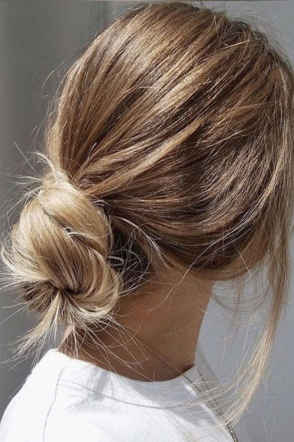 Low bun with twisted rope effect creating elegant movement