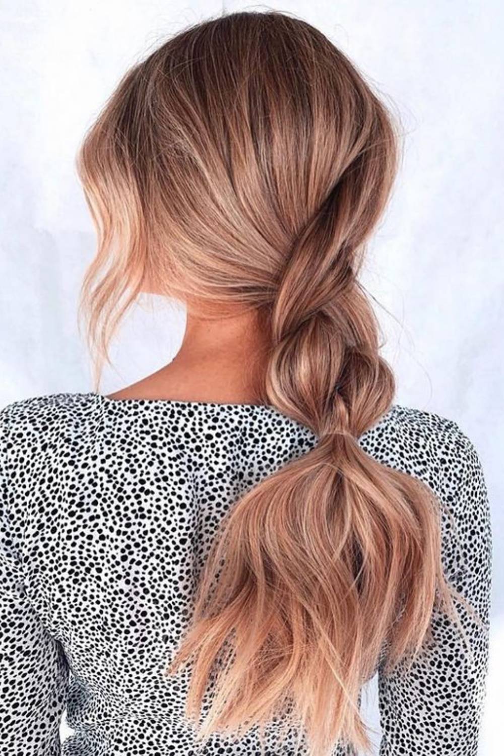 Soft twisted ponytail hairstyle with romantic twists framing the face