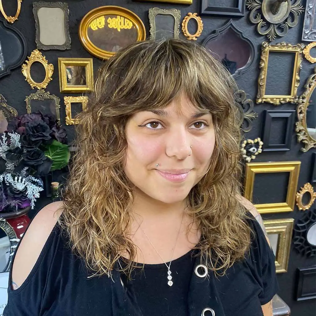 Wavy Bronde Shag With Curtain Bangs for Fine Hair