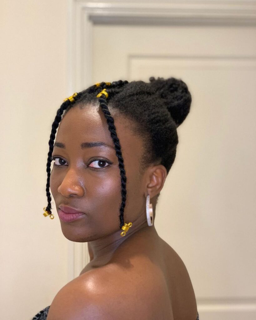 Natural hair bun with parted bangs